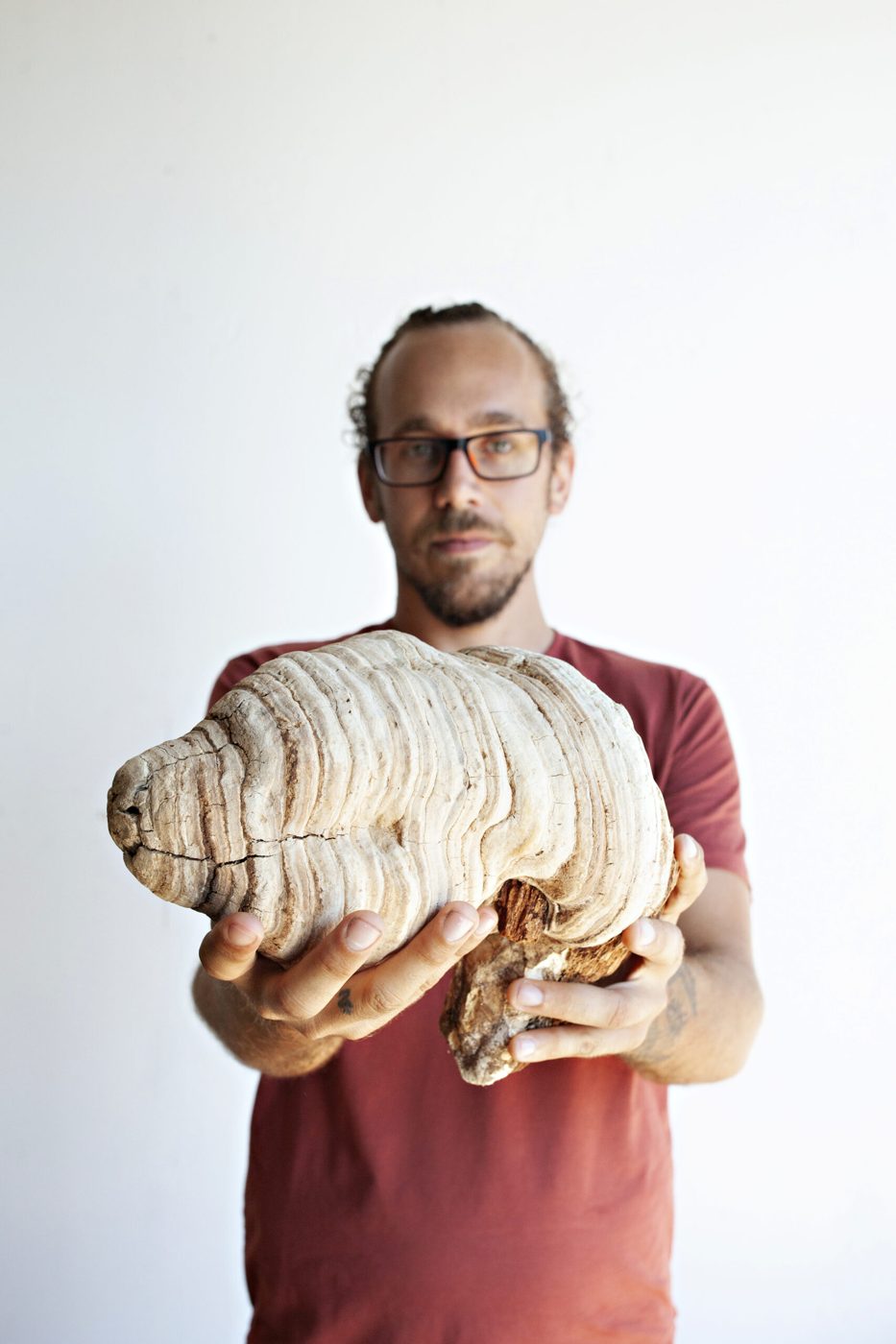 Holding a large wild shelf mushroom